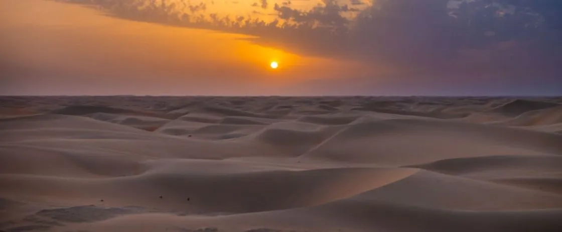 Stunning sunrise over the Sahara desert dunes in Merzouga on the final day of the tour.